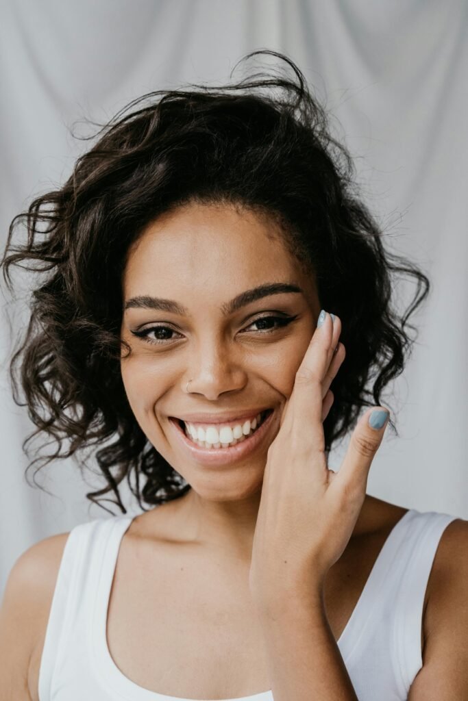 anti-aging ingredients - a woman smiles as she shows off her fresh, clean skin
