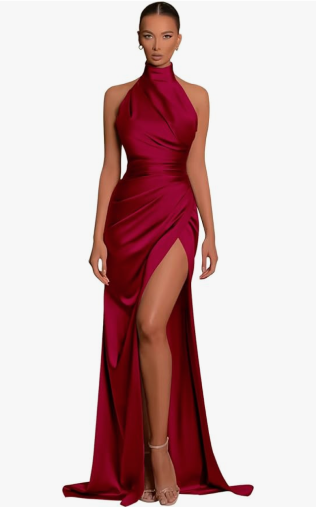 a woman models a satin burgundy evening gown/prom dress. The dress has a thigh high slit