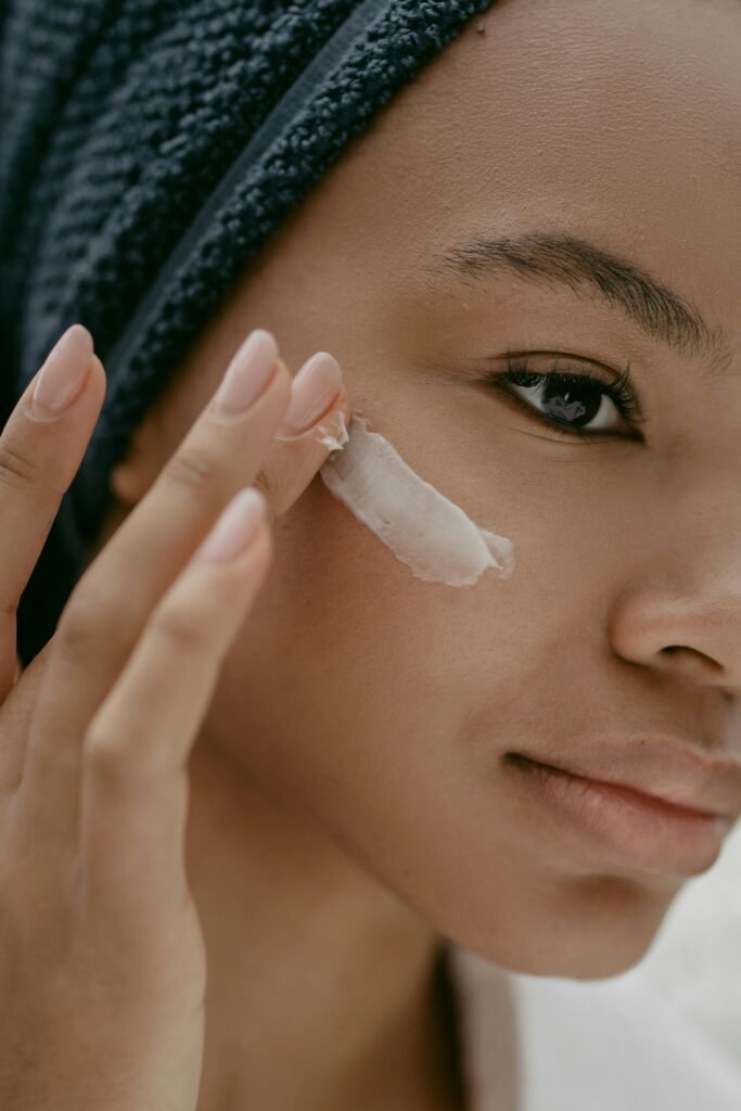 skin care ingredients that work together can do wonders for a youthful healthy glow as a woman applies sunscreen to her face