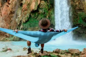 spring break bucket list for teachers-a teacher enjoying the outdoors resting in a hammock