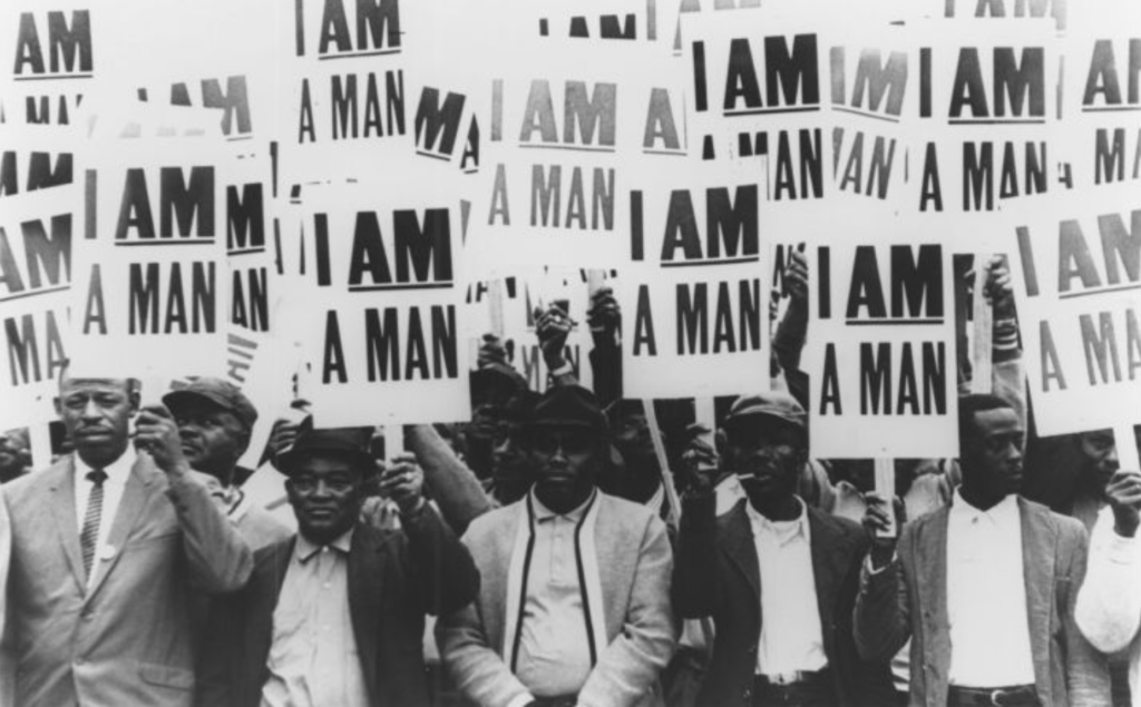 Inspirational Quotes from Black History and The civil rights movement in black and white photos — Memphis sanitation workers hold signs with the slogan "I am a man" during a strike in 1968. Their campaign against discrimination and poor conditions in the workplace brought King to Memphis.