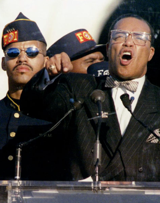 Nation of Islam leader Louis Farrakhan, with his son Mustafa at his side addresses marchers at the Mall in Washington, D.C. October 16, 1995.
