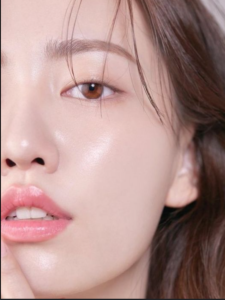 Glass Skin Korean Skincare Routine: half of an asian woman's face is shown emphasizing shiny, dewy skin and natural makeup