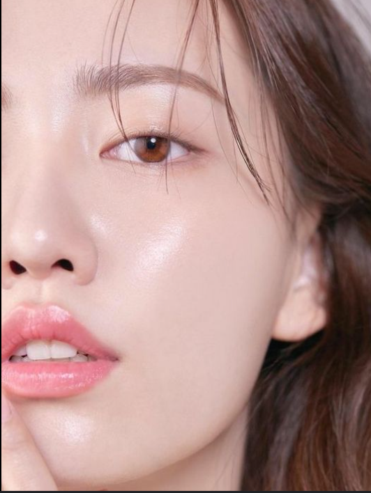Glass Skin Korean Skincare Routine: half of an asian woman's face is shown emphasizing shiny, dewy skin and natural makeup