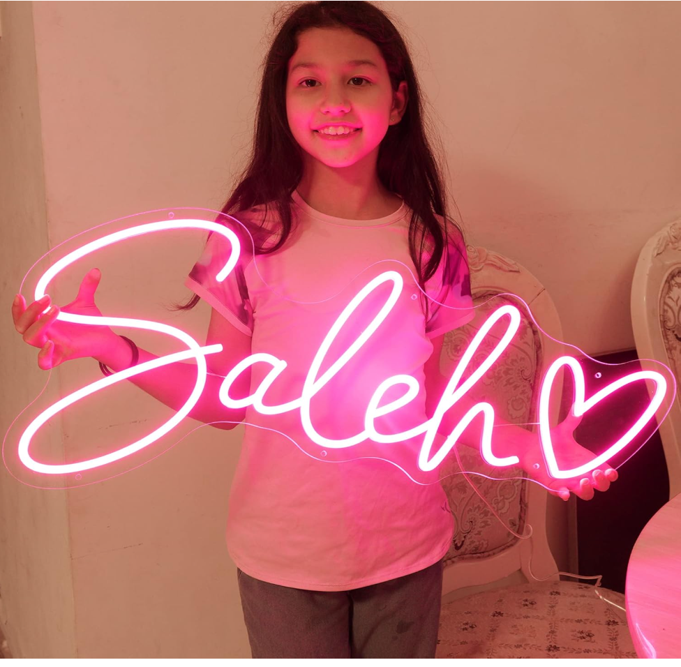 Baddie Aesthetic Quotes - a young girl holds a custom neon name sign