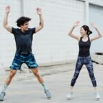 Morning Routine to Speed Up Metabolism: a man and woman are doing jumping jacks