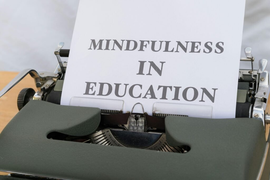 an image of a typewriter with a piece of paper hanging out of the top of it that reads, "MINDFULNESS IN EDUCATION"