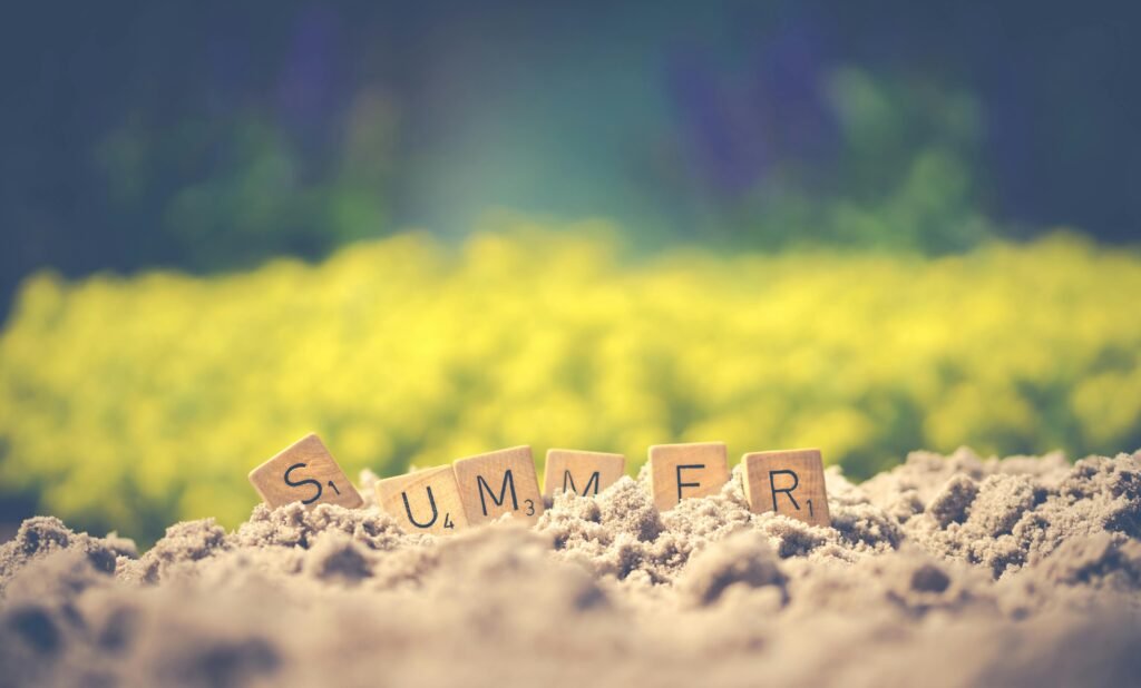 Summer Workout Routine - an outdoor image of summer with the words "summer" spelled out with letters on 5 wooden tiles --1 tile for each letter of the word "summer"