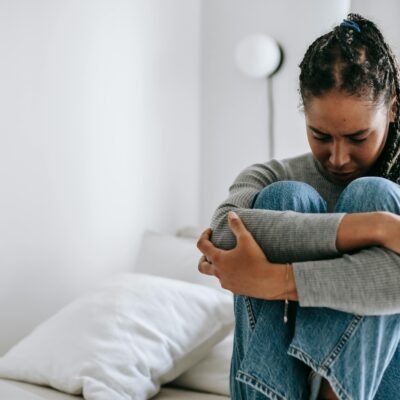 30 day blog challenge - a woman living with regret. Knees to chest, arms hugging her knees to her chest