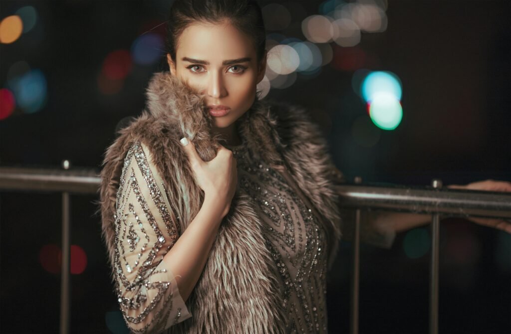 a model wears a fur coat posing facing front (forward facing)