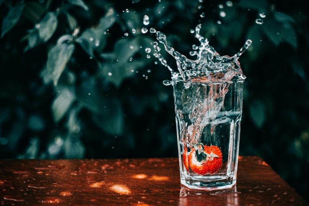What Morning Habits Increase Dementia - glass of water with a strawberry at the bottom of it and a big splash coming out of the glass